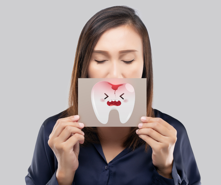 Woman holding broken tooth picture